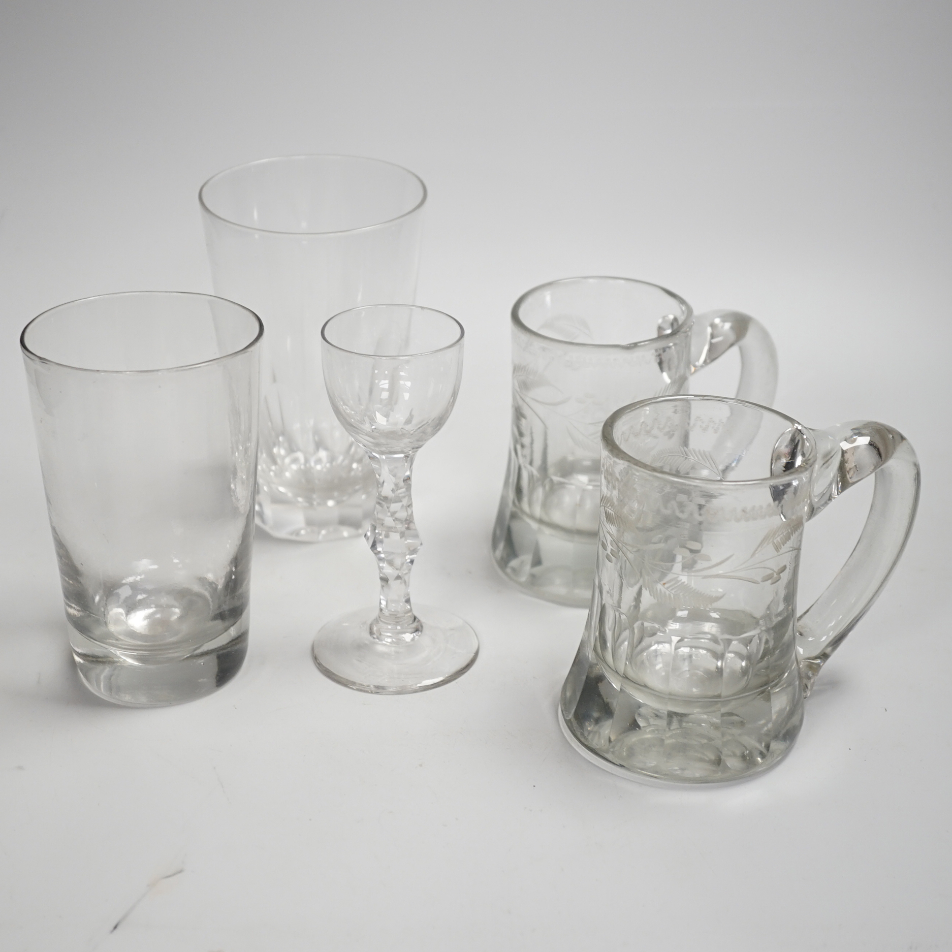 A pair of Victorian pub tankards, engraved with floral motifs and one acid etched with HALF PINT VR and Crown and the number 265, together with two 19th century faceted stem wine glasses, a trumpet glass and two large 19